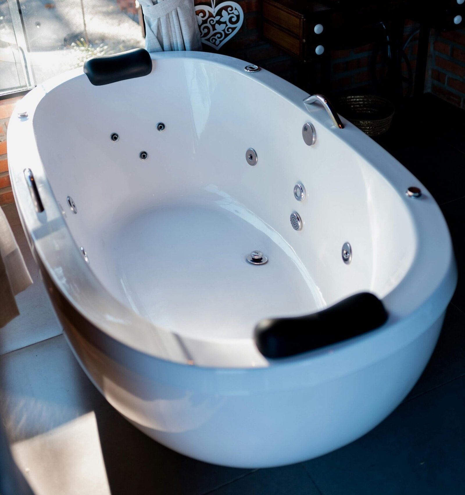 Elegant bathroom featuring a contemporary whirlpool bathtub and stylish decor.