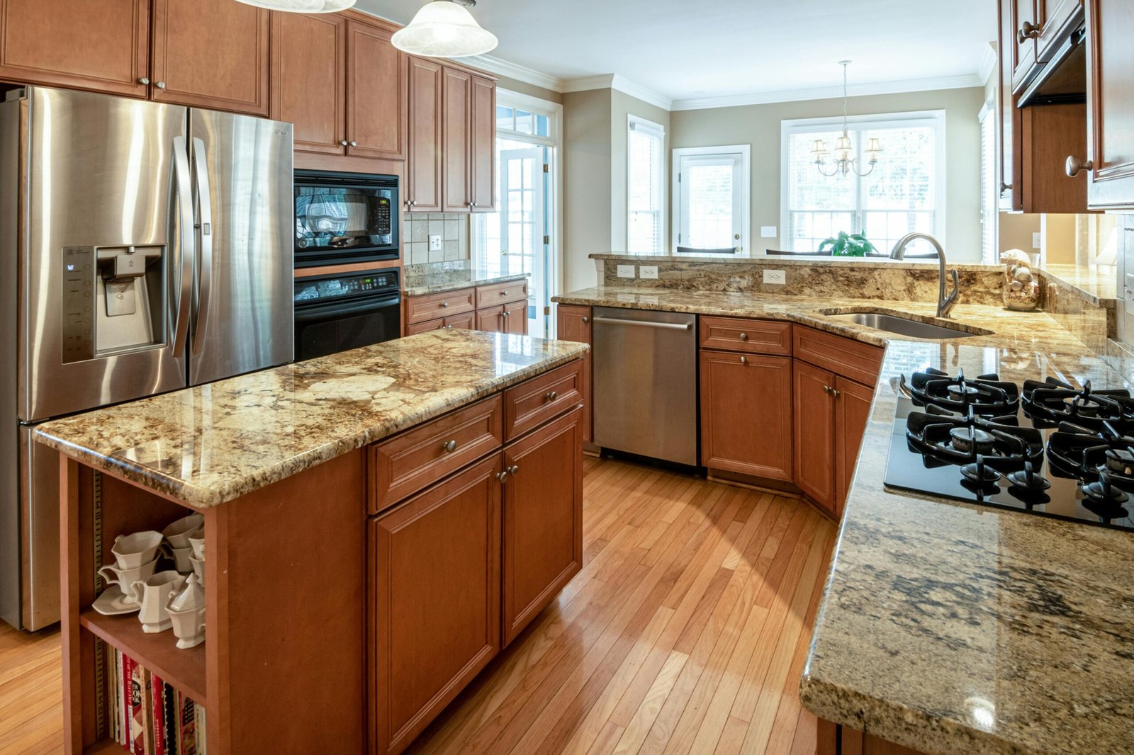 A luxurious kitchen interior featuring granite countertops and modern appliances.