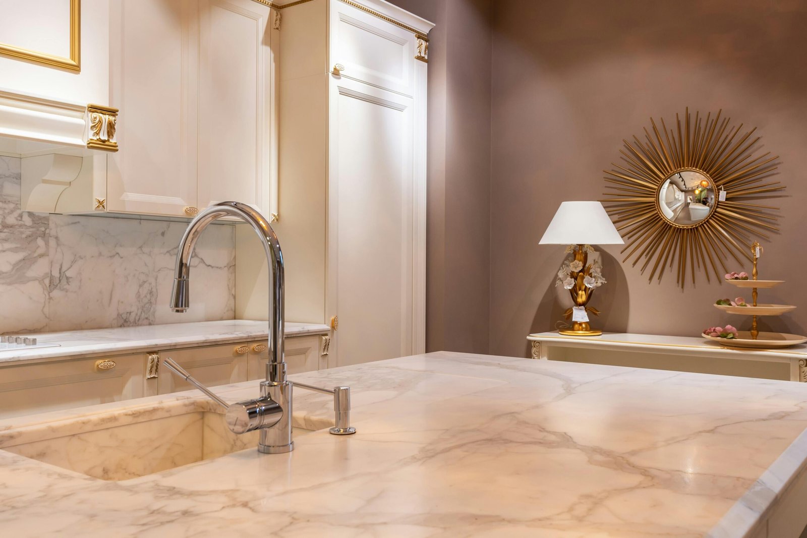 Bright kitchen with marble countertops, modern faucet, and stylish decor.