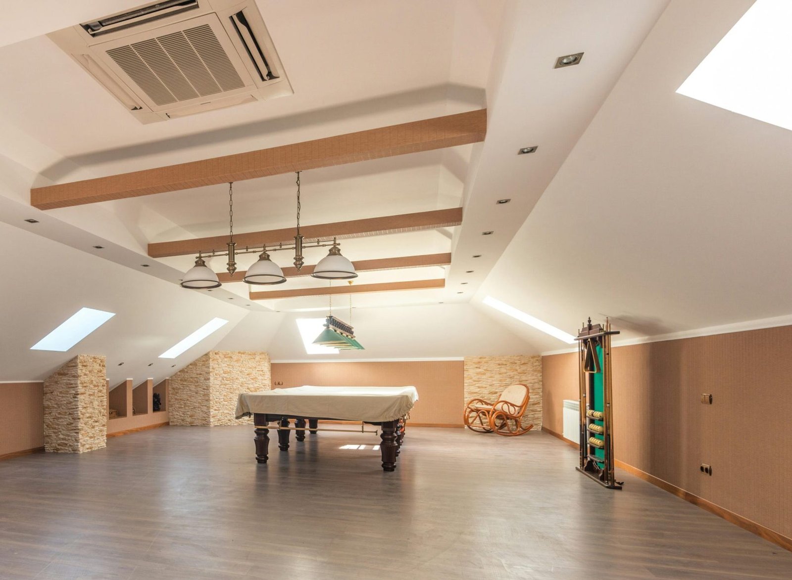 Bright attic space featuring a sleek pool table and skylights, perfect for leisure.